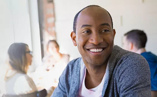 Man in coffee shop smiling