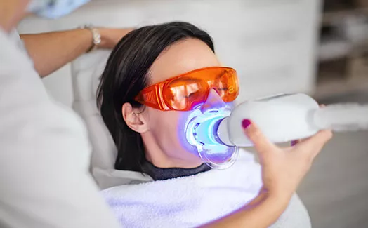 Patient undergoing teeth whitening treatment